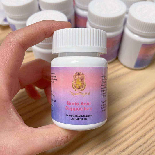 Pure Boric Acid Suppository bottle in hand for intimate health support, featuring 30 capsules for pH balance.