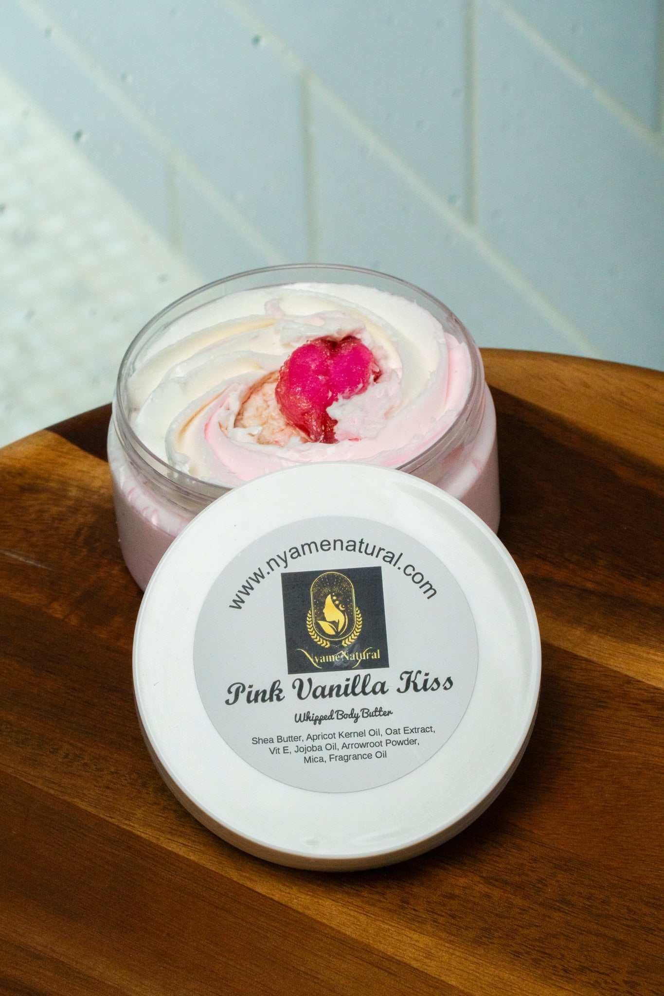 Pink Vanilla Kiss body butter in a jar, showcasing its creamy texture and sweet pink fragrance.