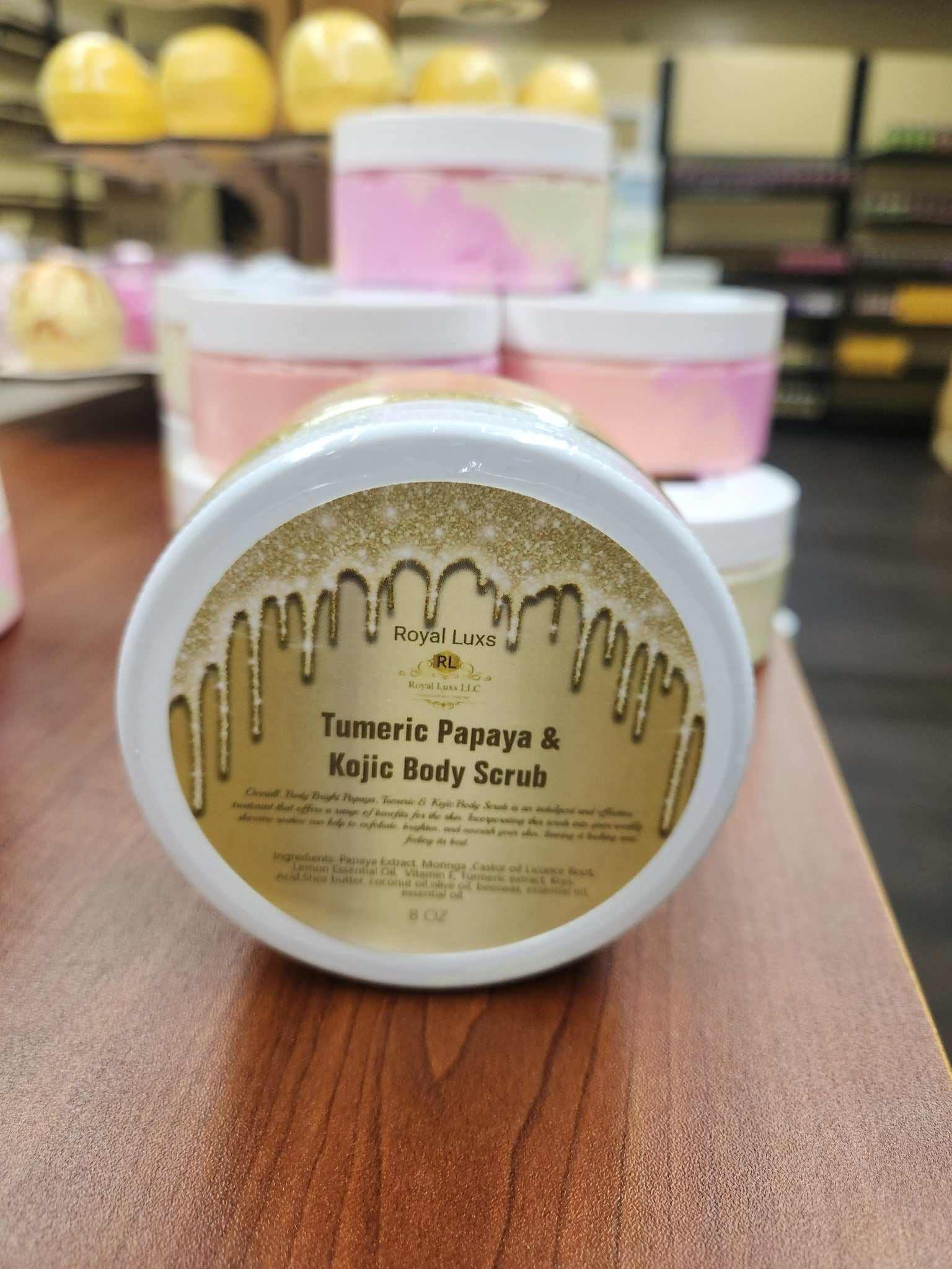 Bright Turmeric Papaya and Kojic Body Scrub jar on display, promoting skin brightness and rejuvenation.