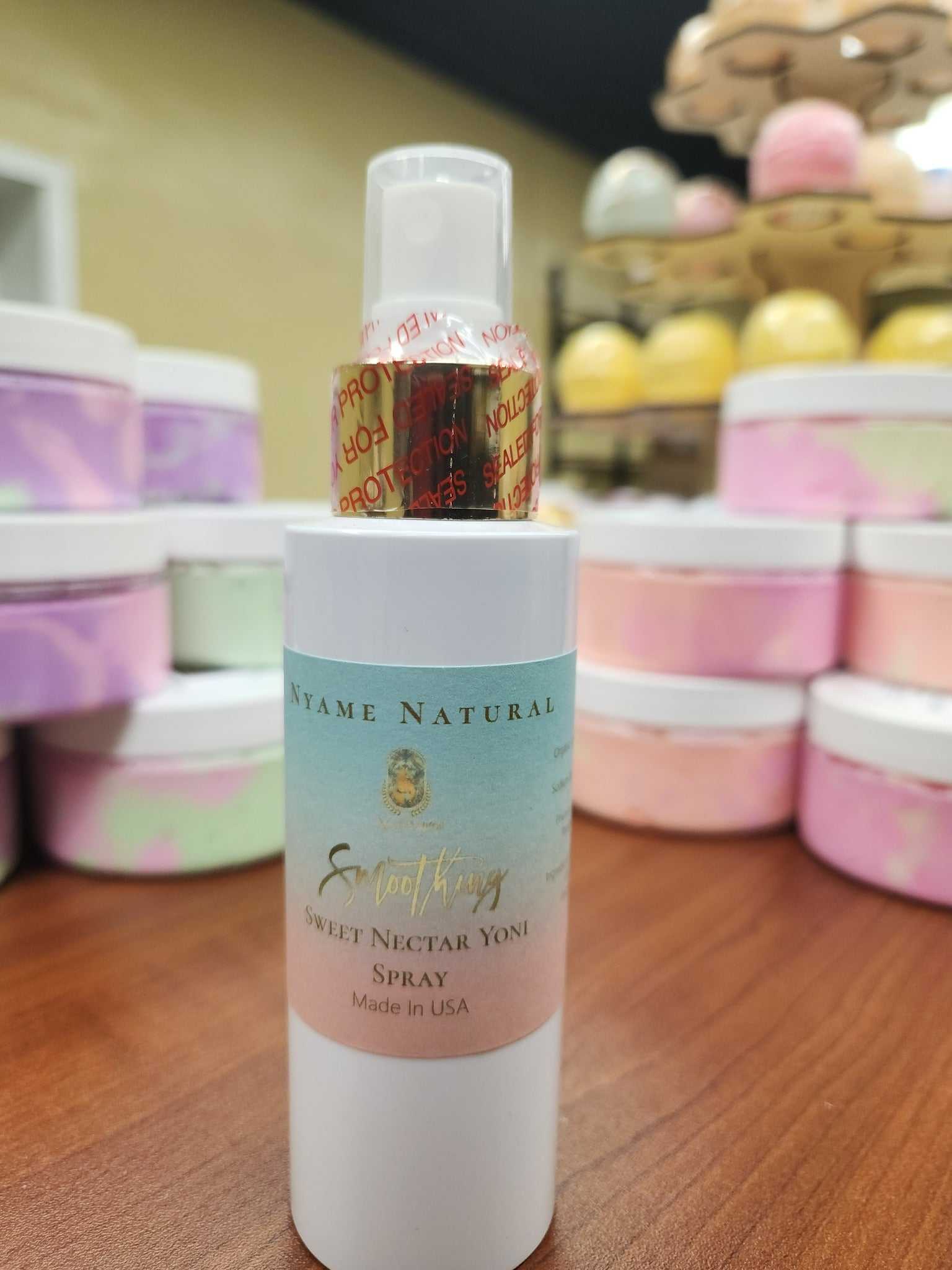 Sweet Yonie Spray bottle on a wooden table surrounded by pastel-colored jars, ideal for freshening up.