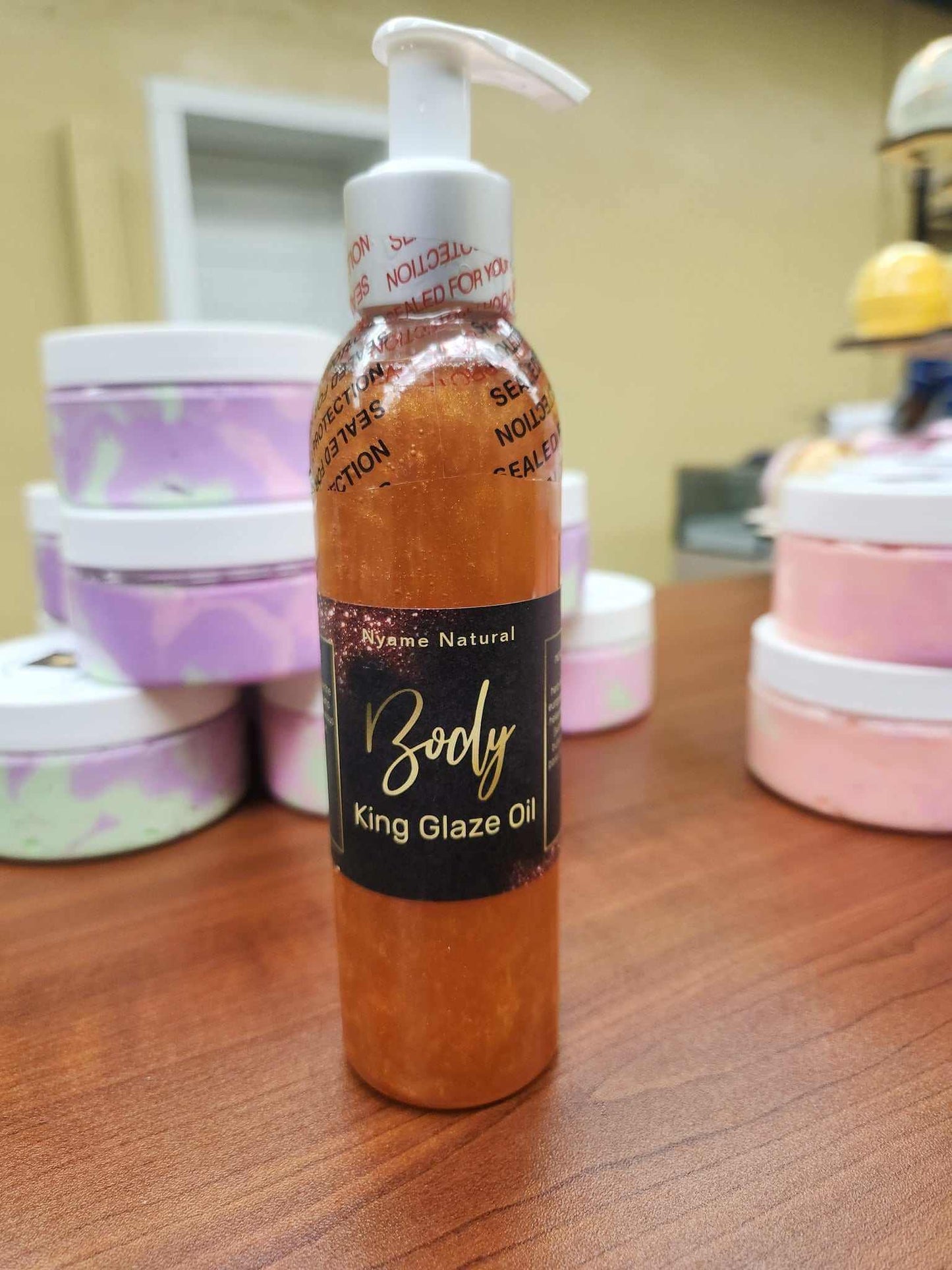 King Glaze Pheromone Oil bottle with 24k gold shimmer on display.