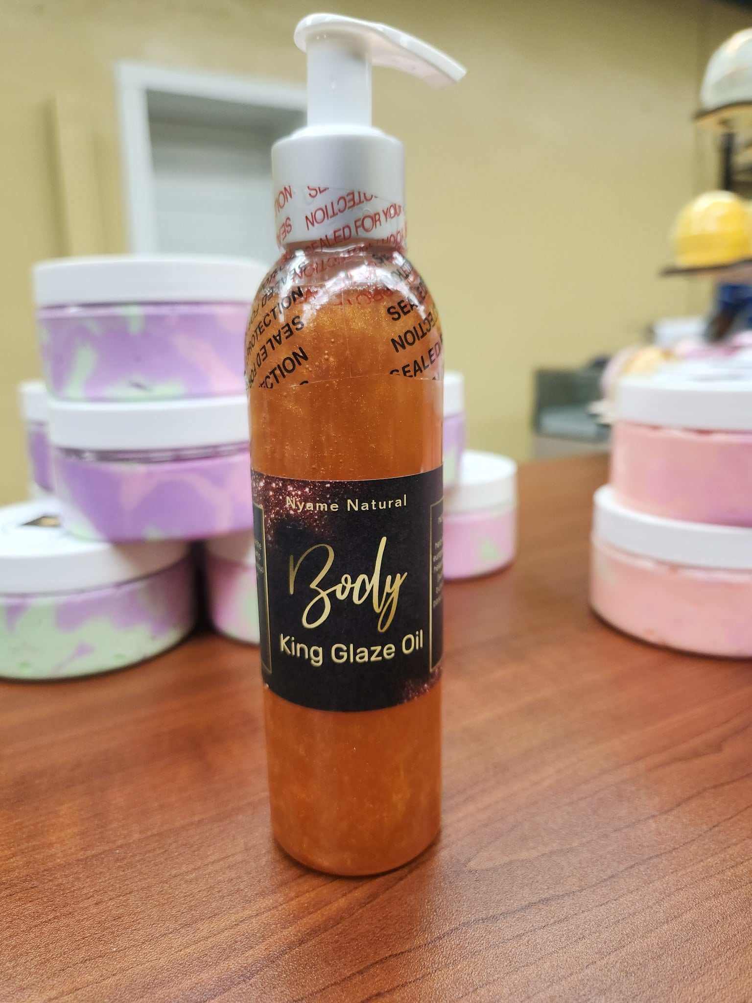 King Glaze Pheromone Oil bottle with 24k gold shimmer on display.