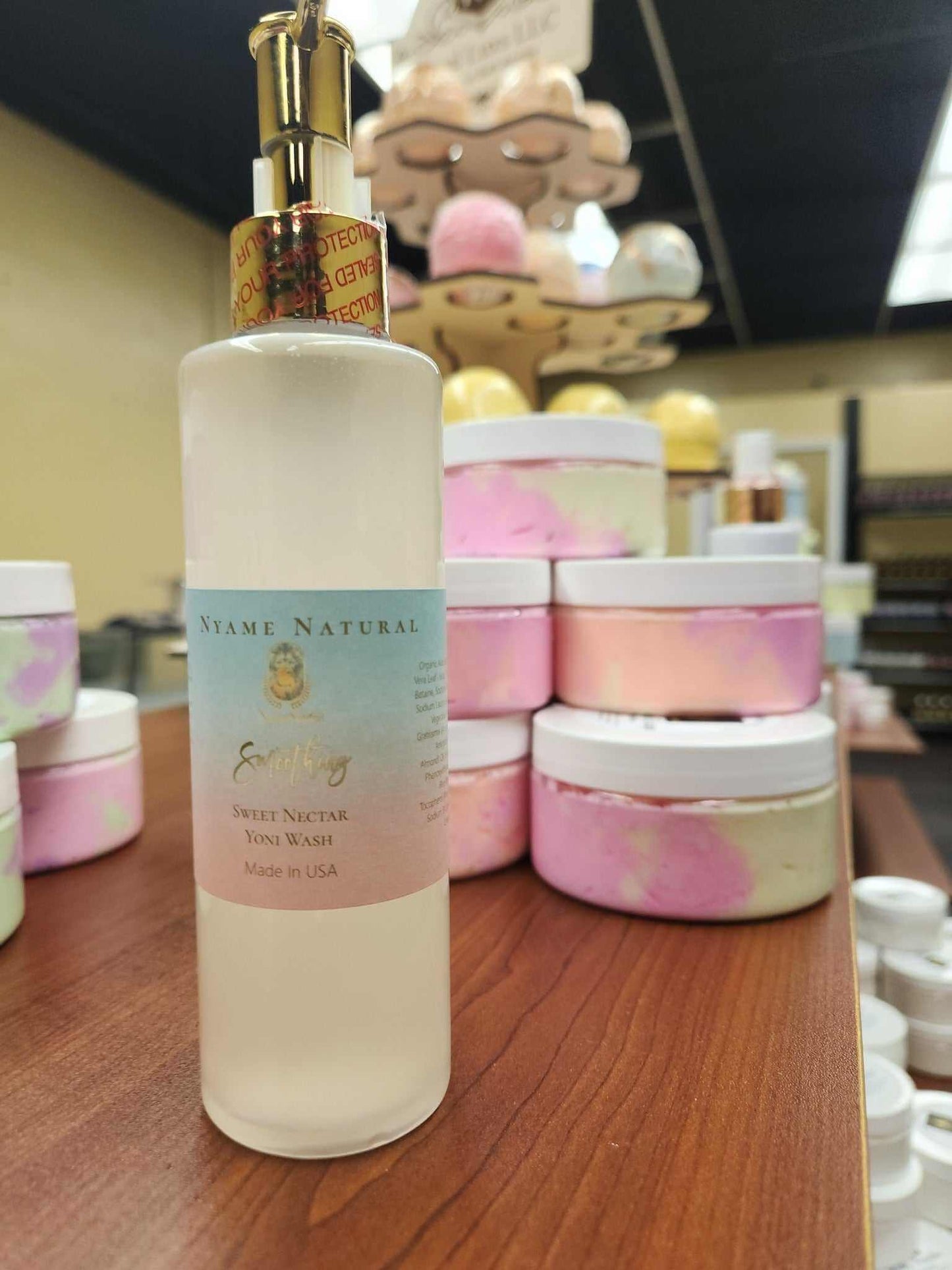 Sweet Yonie Wash displayed on a table, featuring a refreshing strawberry scent and vibrant packaging.