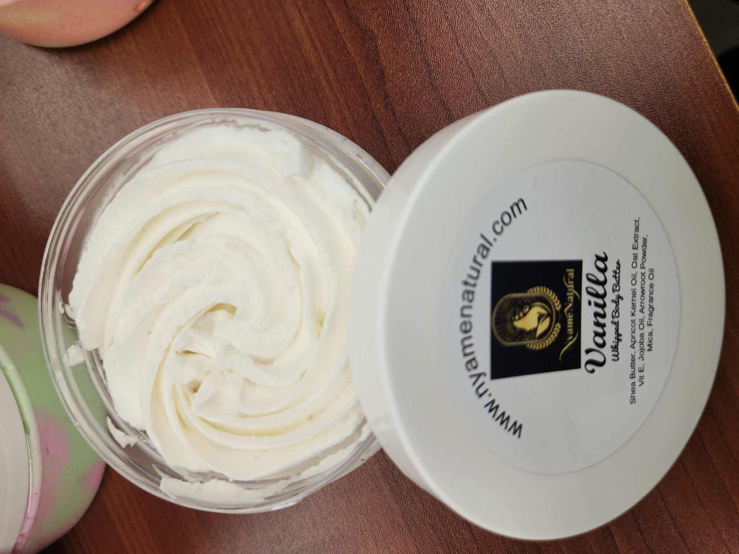 Luxurious Vanilla Body Butter in a clear jar, showcasing creamy texture and smooth consistency.