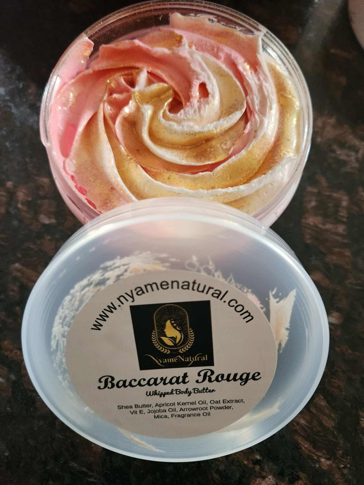 Baccarat Rouge Body Oil showcasing a silky body butter with pink and gold swirls in a clear container.