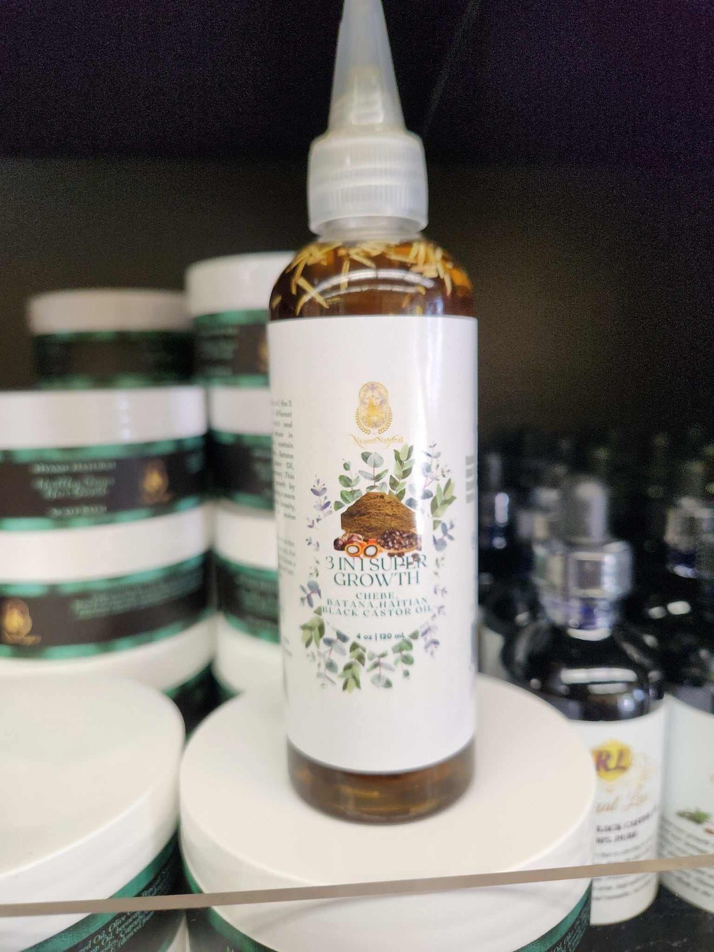 3 in 1 Supergrowth Batana Chebe Haitian Black Castor Oil bottle on shelf, promoting natural hair growth and health.