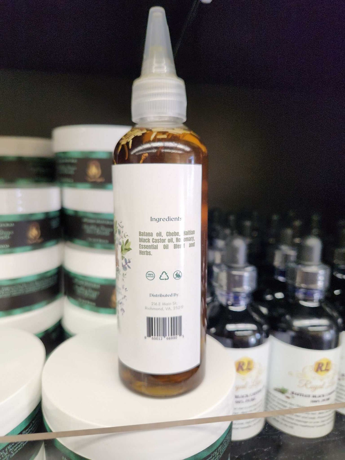 Bottle of 3 in 1 Supergrowth Batana Chebe Haitian Black Castor Oil showing ingredient list.