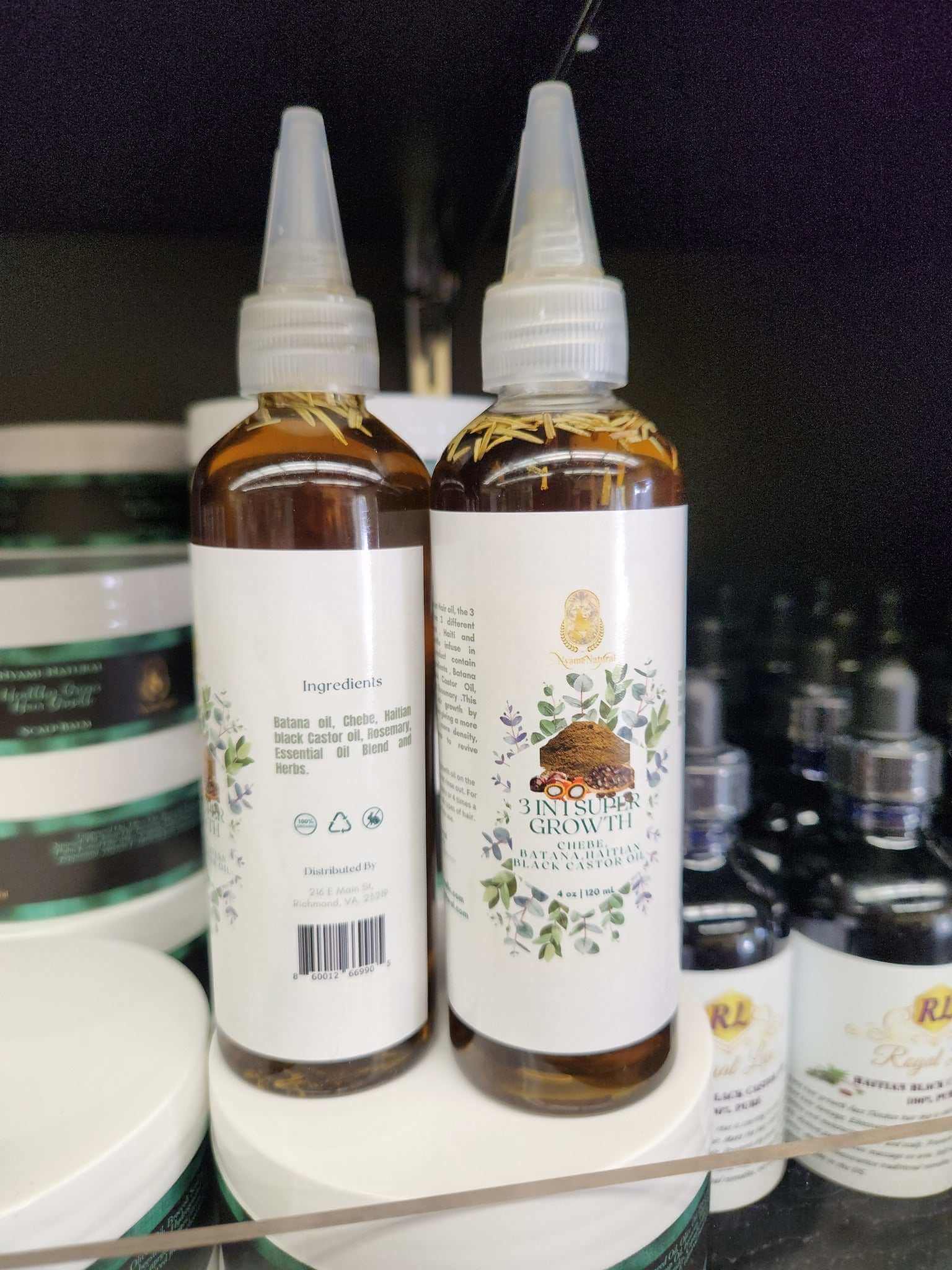 3 in 1 Supergrowth Batana Chebe Haitian Black Castor Oil bottles on a shelf, showcasing natural hair growth benefits.