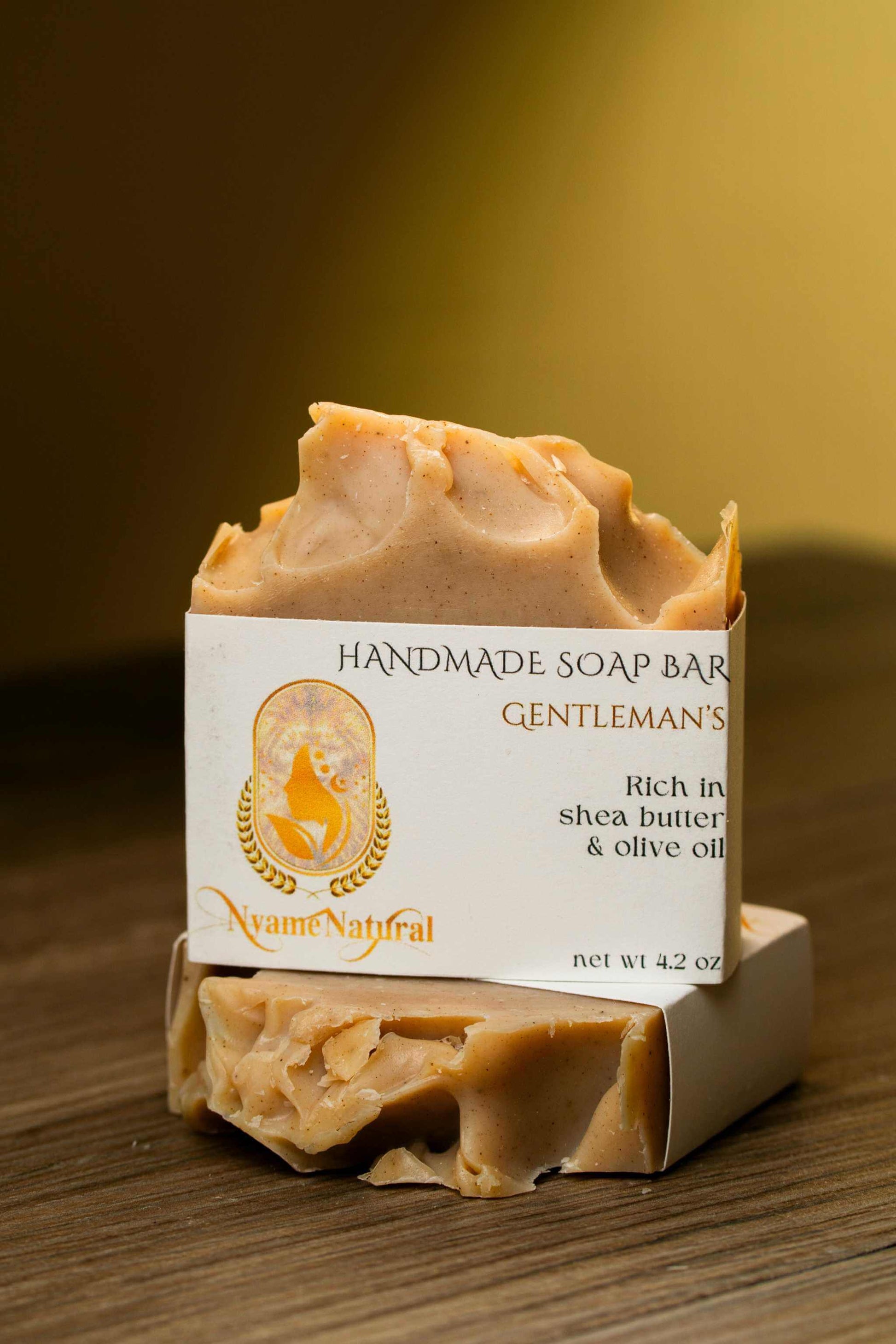 Handmade Gentlemen's luxurious soap bar with shea butter and olive oil, showcasing its creamy texture and elegant packaging.