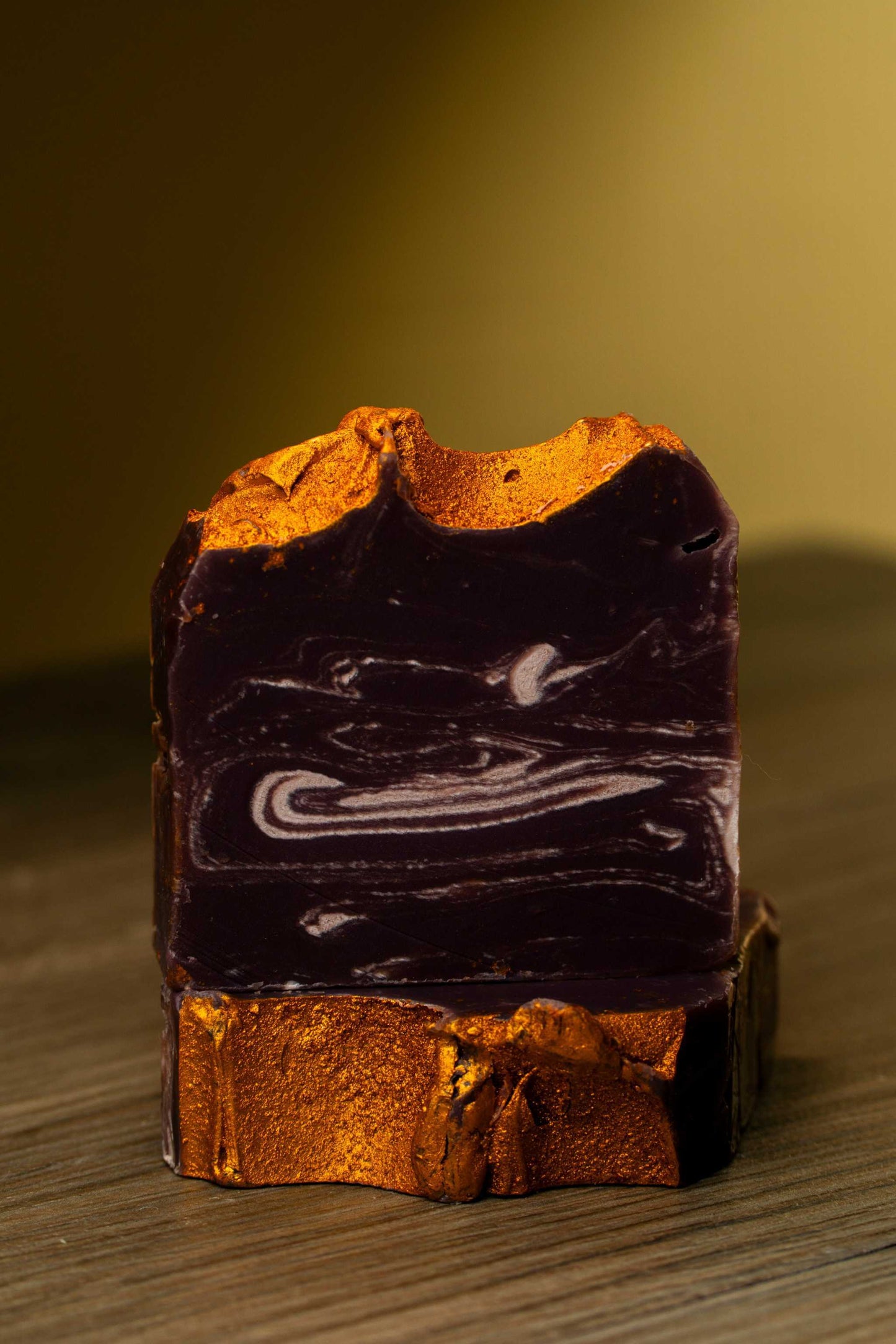 Lavender Gold handcrafted soap showcasing rich purple and gold swirls, perfect for skin pampering and moisture retention.