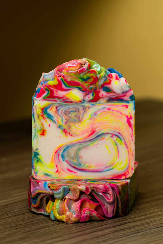 Colorful Living Color Bar Soap showcasing vibrant swirls on a wooden surface, ideal for skincare.