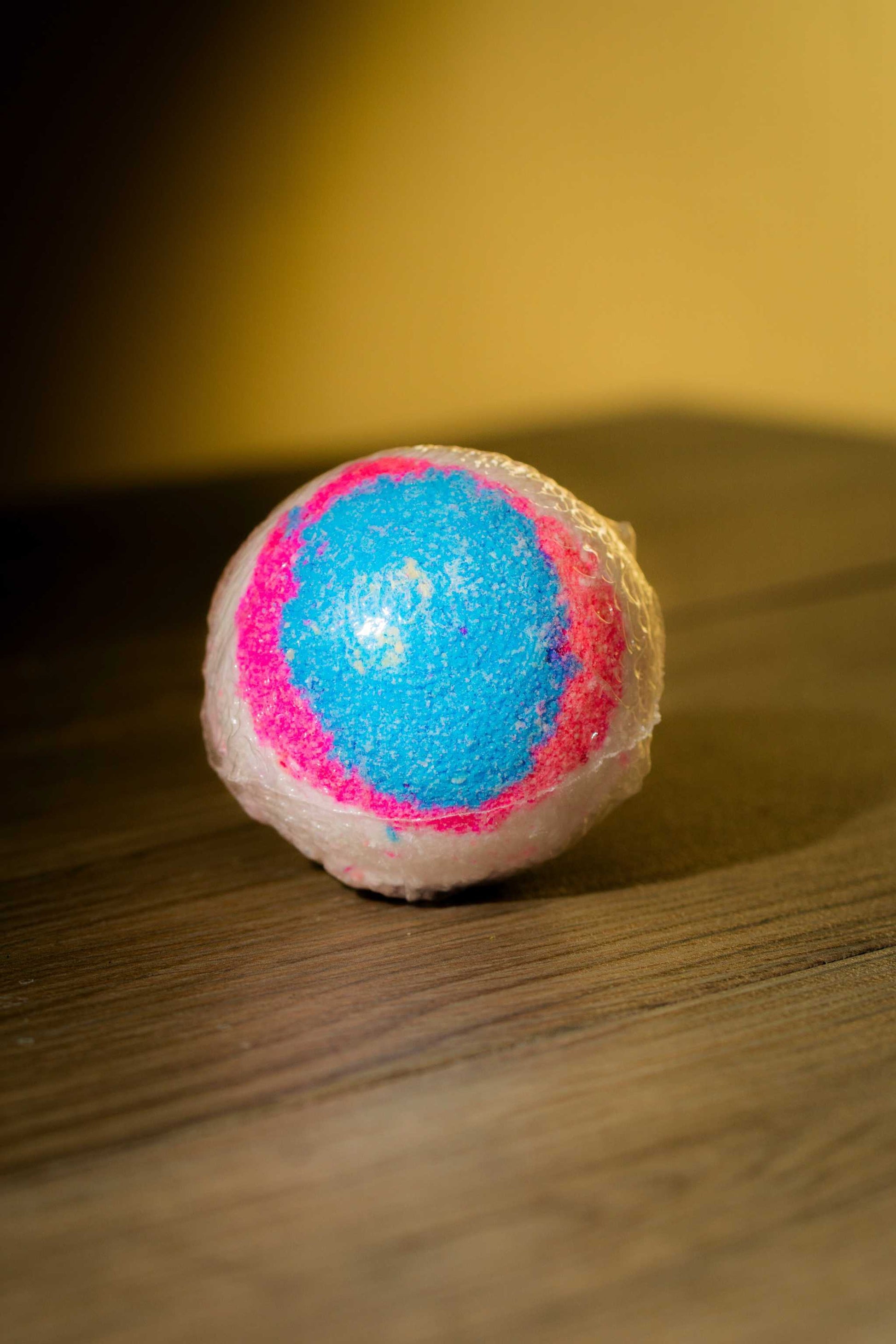 Vibrant Luxurious Body Bath Bomb in blue and pink, perfect for a relaxing bath experience.