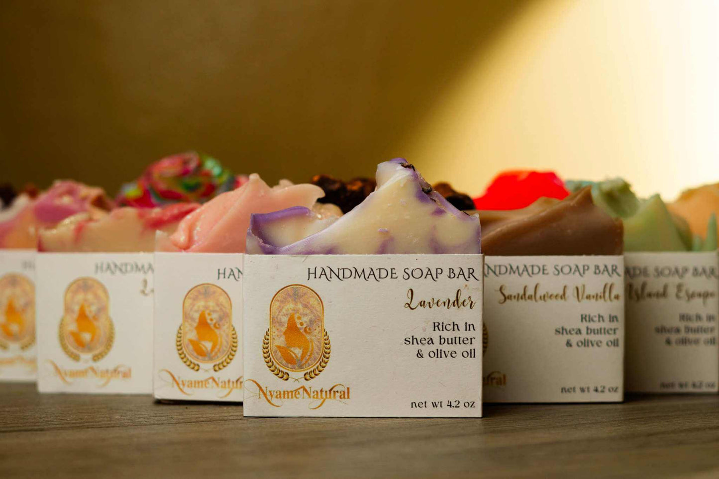 Variety of handmade soap bars, including lavender and sandalwood, highlighting their natural ingredients and luxurious appeal.