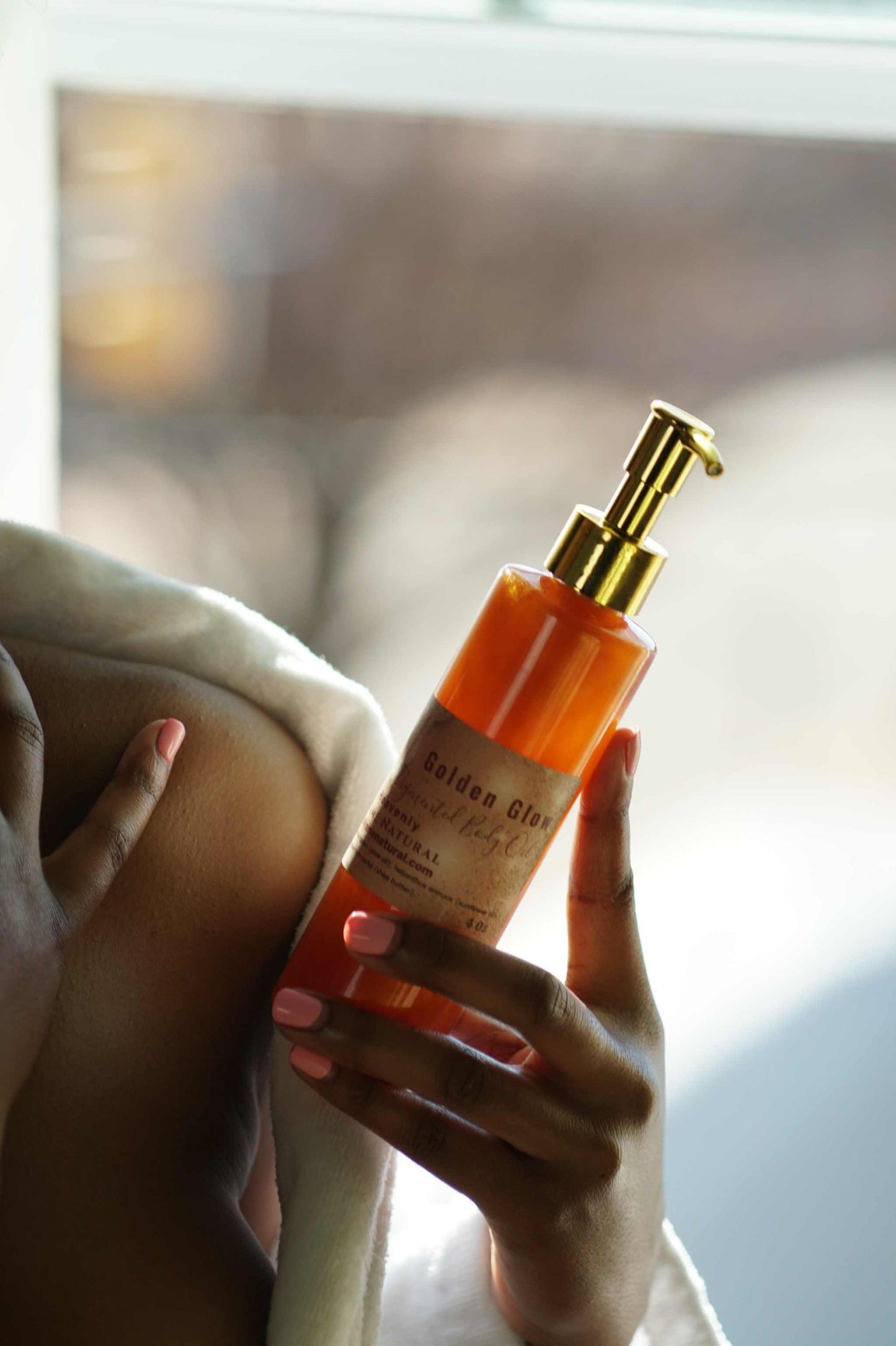 Copper Pigmented Pheromone Body Oil enhancing glowing skin, held by a person in a cozy setting.