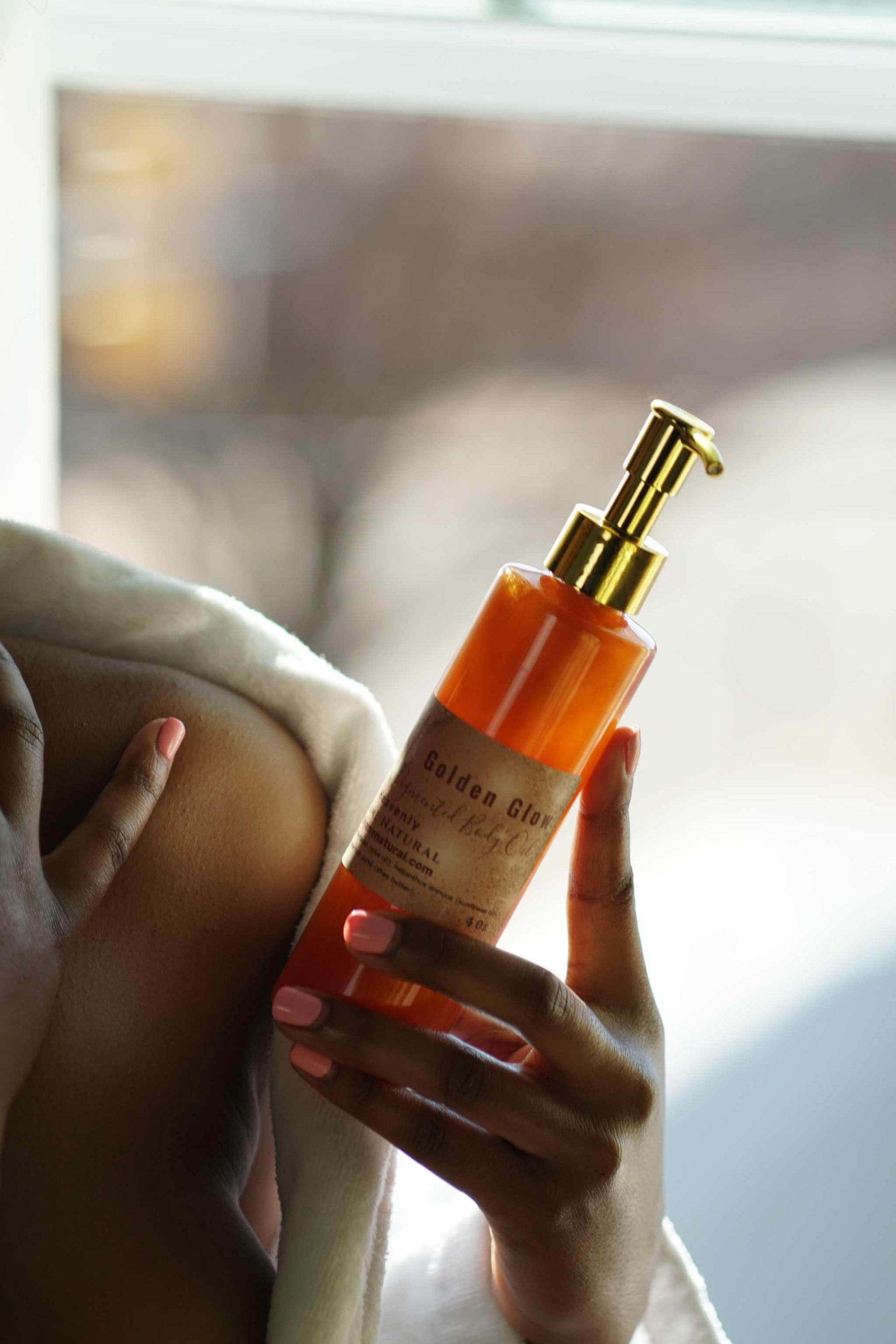 Copper Pigmented Pheromone Body Oil enhancing glowing skin, held by a person in a cozy setting.