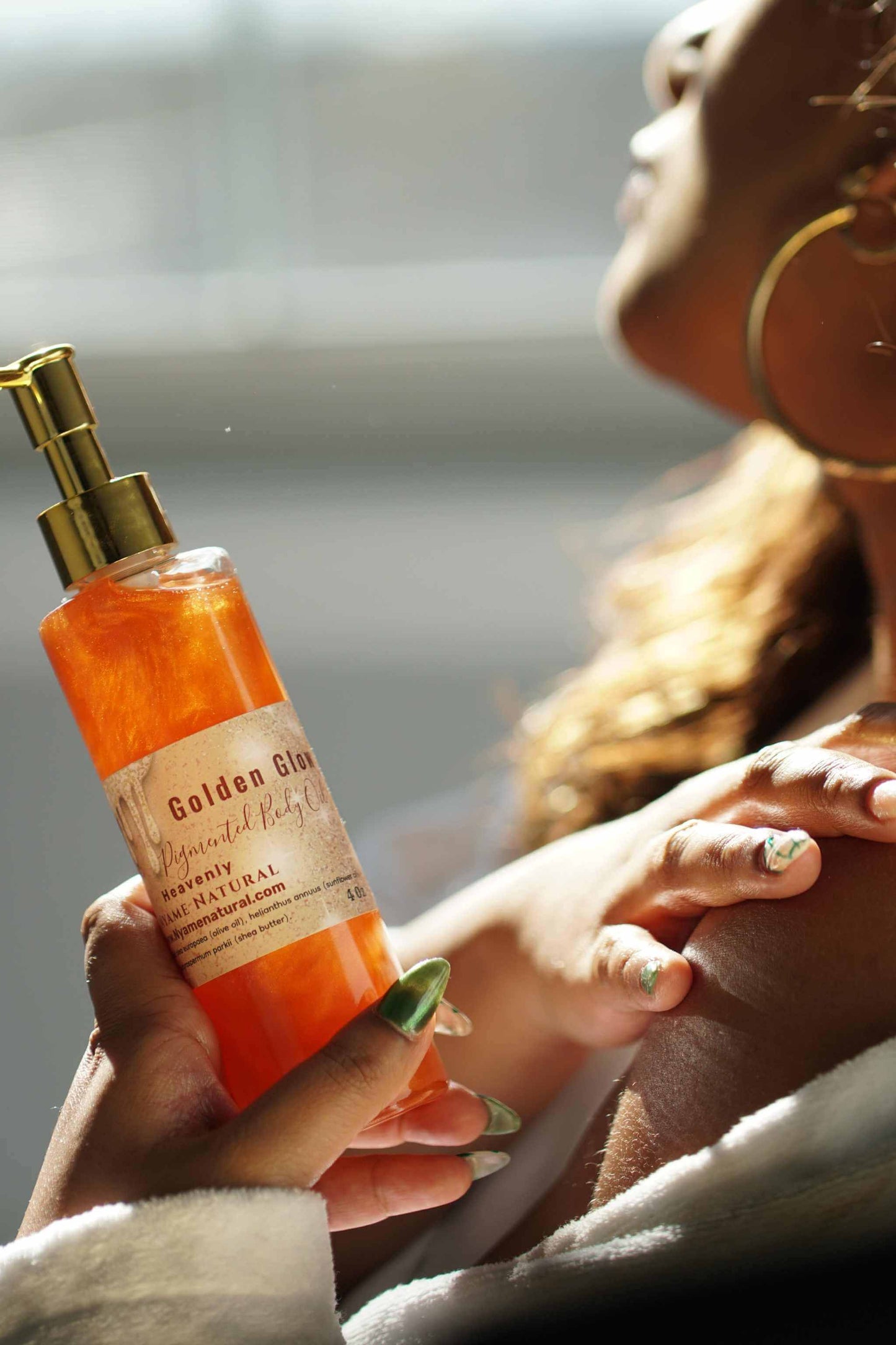 Copper Pigmented Pheromone Body Oil being applied for a radiant glow with natural ingredients.