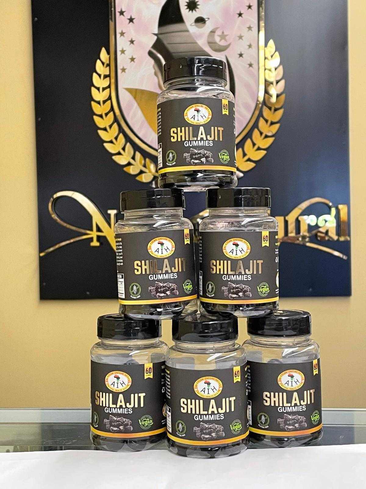 Pyramid of AIH Shilajit Gummies bottles showcasing natural ingredients and energy-boosting benefits.