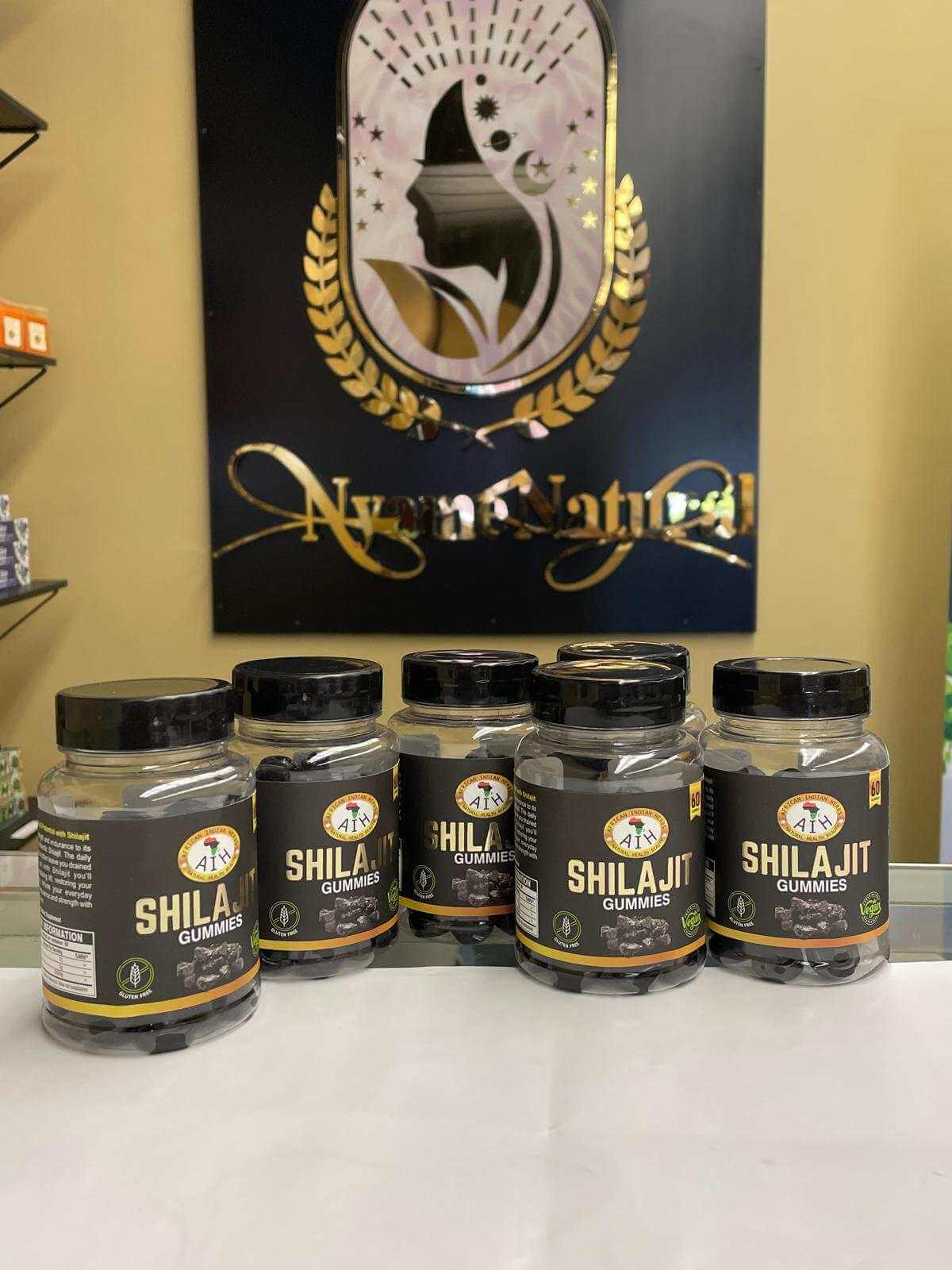 AIH Shilajit Gummies displayed in jars on a counter, promoting energy and cognitive clarity.