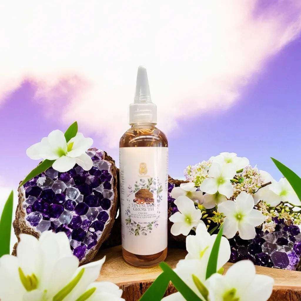 3 in 1 Supergrowth Batana Chebe Haitian Black Castor Oil in a beautiful setting with flowers and crystals.