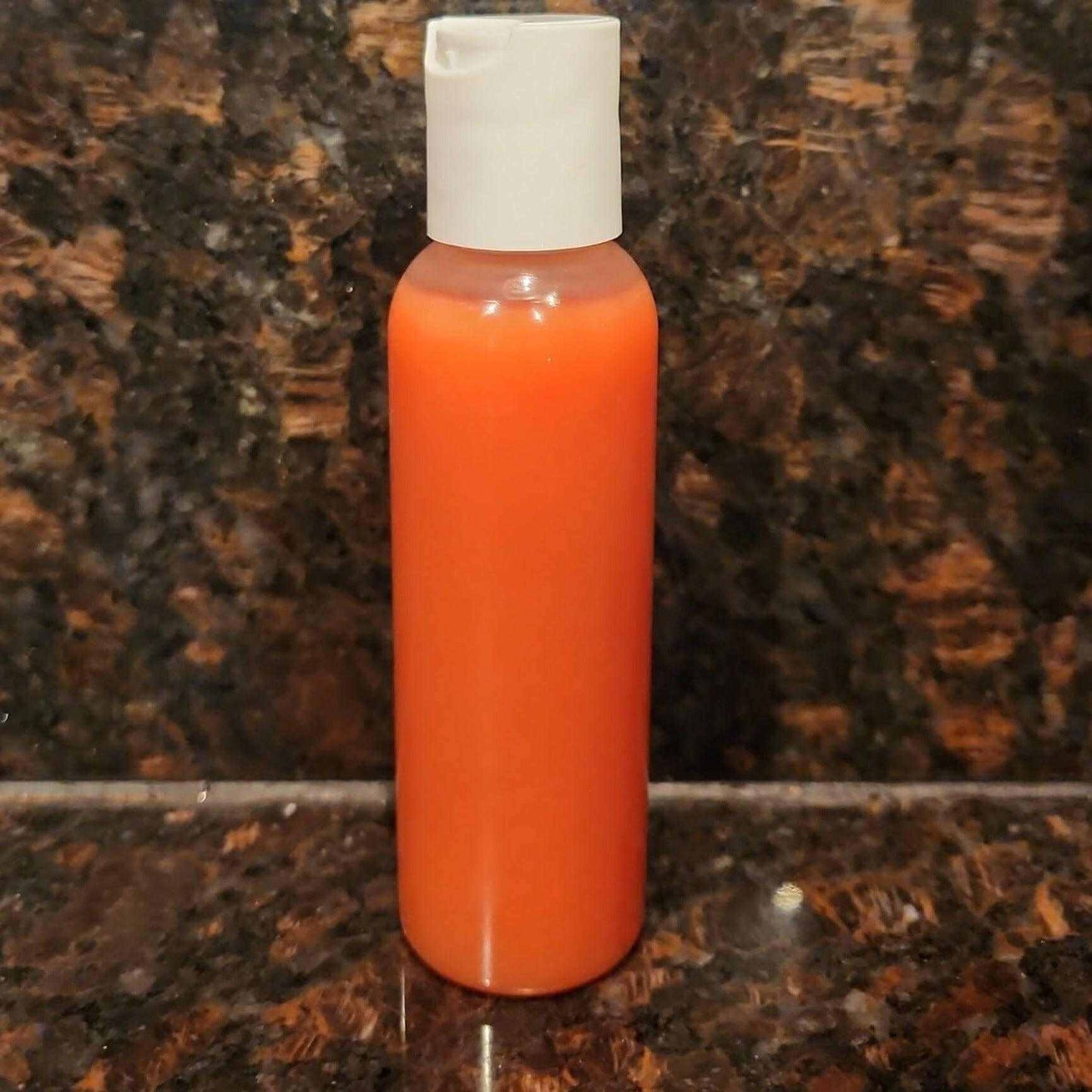 Dark Inner Thighs & Armpits Solution Serum in a small orange bottle on a marble countertop.