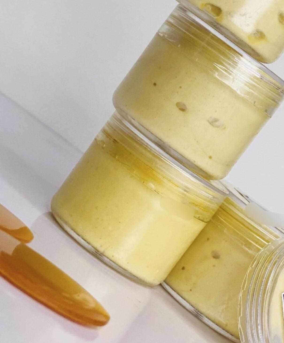 Close-up of yellow face glow cream jars and applicator, ideal for brightening and evening skin tone.