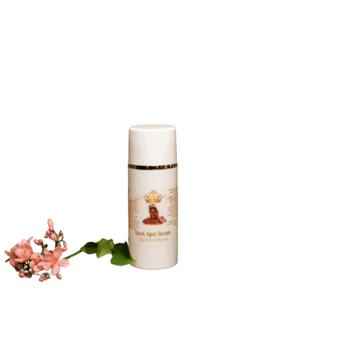 Kojic Dark Spot Serum bottle next to pink flowers, targeting dark spots for brighter skin.