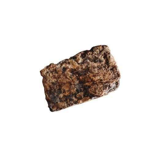 Chunk of 100% raw organic African black soap from Ghana, ideal for acne and skin care.