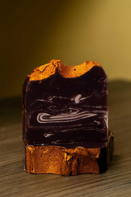 Lavender Gold handcrafted soap showcasing rich purple and gold swirls, perfect for skin pampering and moisture retention.