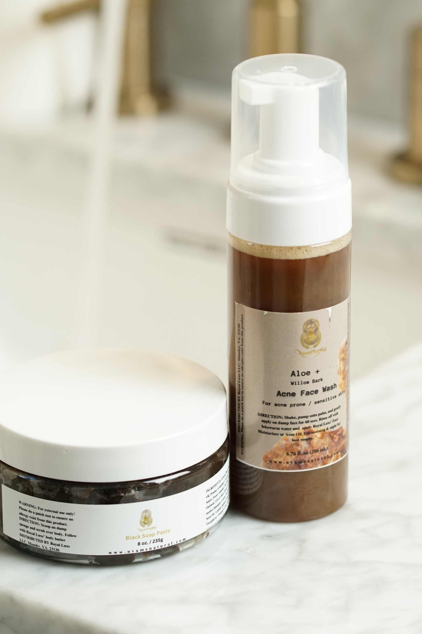 Natural Face Acne Wash and Black African Paste for oily and sensitive skin on marble countertop.