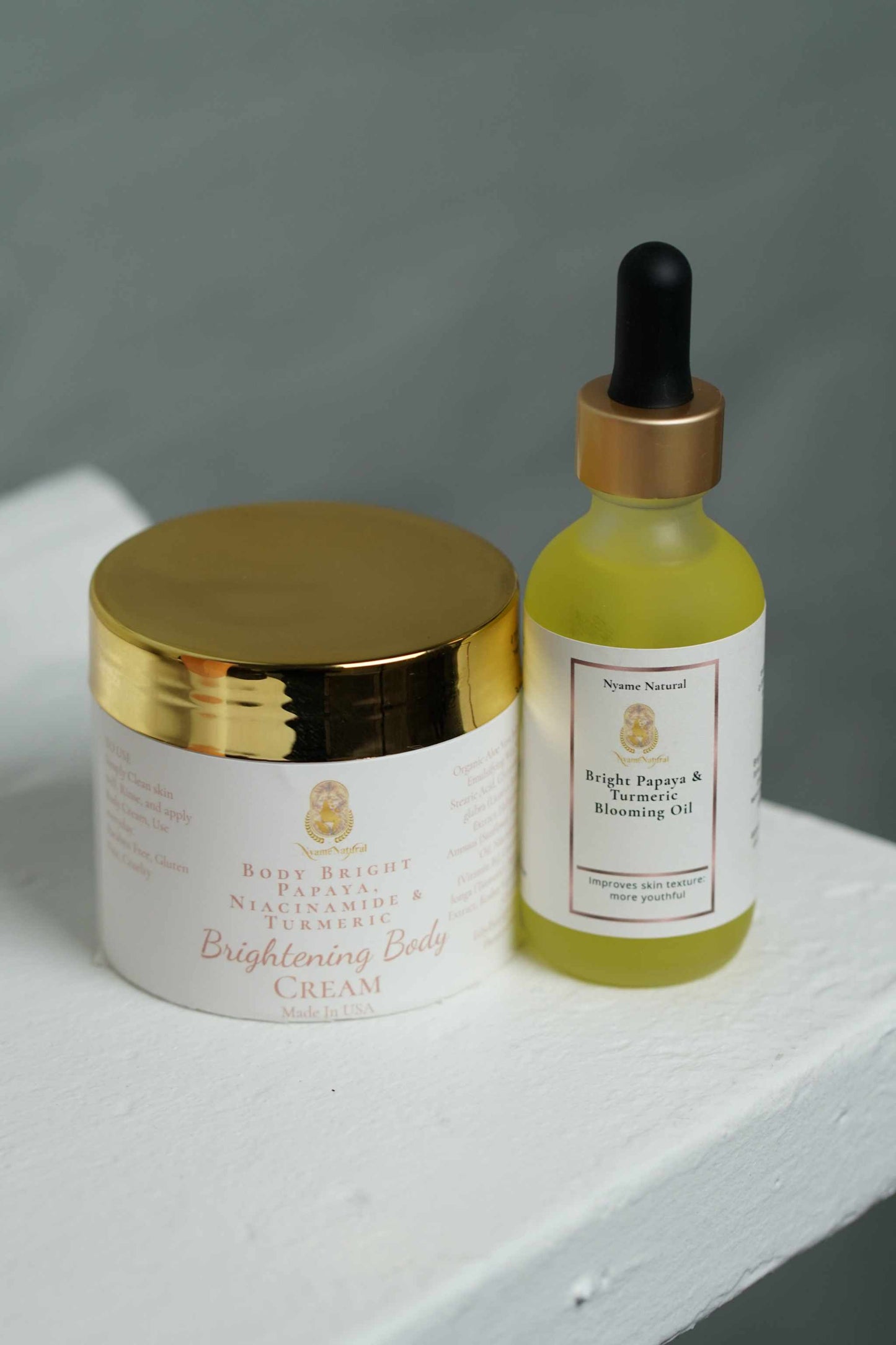 Bright Papaya & Turmeric Blooming skincare kit with body cream and face oil for radiant skin.