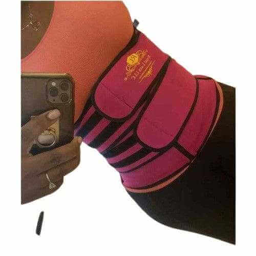 A pink waist trainer worn by a person, designed to shape and slim the waist for a flattering silhouette.